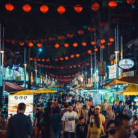 crowd of people walking in jalan alor food street is a popular tourist attraction in kuala lumpur city center - food stock pictures, royalty-free photos & images