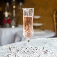 crystal champagne flute, on an white lace tablecloth, in an elegant restaurant - home decoration stock pictures, royalty-free photos & images