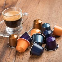 cup of coffee with capsules, nestle nespresso kaffeekapseln - coffee stockfoto's en -beelden