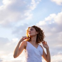 curly hair woman outdoors sky background - fashion stock pictures, royalty-free photos & images