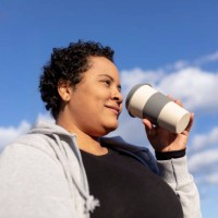 curvy and female student with coffee to go cup in berlin - junk food stock pictures, royalty-free photos & images