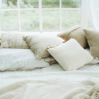 cushions, pillows, blanket and plaid on a bed against a window. - garden decoration stock pictures, royalty-free photos & images