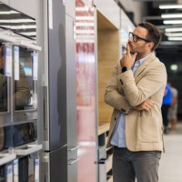 customer checking refrigerators in an appliance store - home decoration stock pictures, royalty-free photos & images