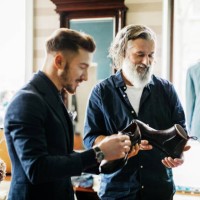 customer looking at shoes in menswear store - fashion stock pictures, royalty-free photos & images