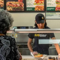 Customer orders food at a Subway fast-food restaurant on April 29, 2022 in Houston, Texas. The fast-food chain closed over 1,000 stores last year and...