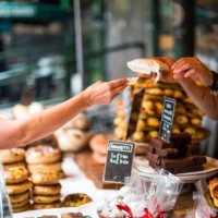 customer paying for sweet pastry using cash at food market - junk food stock pictures, royalty-free photos & images