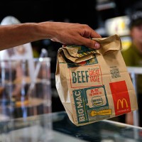Customer takes a McDonald's Corp. Bag of food inside a McDonald's restaurant in Manchester, U.K., on Monday, Aug. 10, 2015. McDonald's Chief...