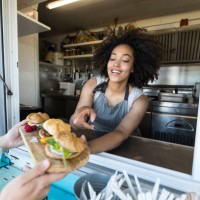 customer taking burgers from food van - junk food stock pictures, royalty-free photos & images