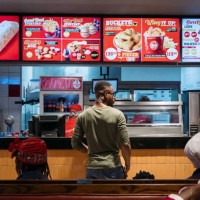 Customers await their orders at the counter of a fast food restaurant in Accra, Ghana, on Monday, April 24, 2023. As many as 48 million people across...