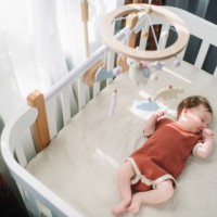 cute baby girl in her crib - home decoration stockfoto's en -beelden