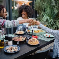 cute girl having dinner with parents - garden decoration stock pictures, royalty-free photos & images