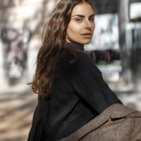 cute girl with brown eyes dressed in a brown coat and a black shirt looks curiously at the camera. - fashion stock pictures, royalty-free photos & images
