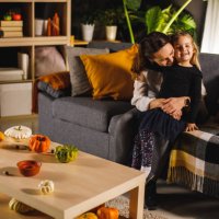 cute little girl smiling at camera while cuddling with her mother - home decoration stock pictures, royalty-free photos & images