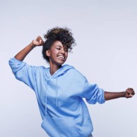 dancing young woman in blue hoodie - fashion stock pictures, royalty-free photos & images