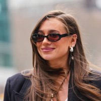 Danielle Bernstein wears black sunglasses, silver earrings, black necklace silver pendant, black oversized blazer jacket, outside La Pointe, during...