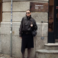 Darja Barannik wears black skirt, dark brown leather jacket, black bag and sunglasses outside the Garment fashion show during the Copenhagen Fashion...