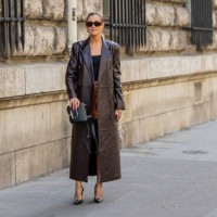 Darja Barannik wears brown leather short, brown shorts, black top, black bag outside Hermes during the Womenswear Spring/Summer 2024 as part of Paris...