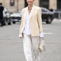 Deborah Reyner Sebag is seen wearing a cream jacket, white button down shirt, white pants, black shoes and black sunglasses outside the Dior show...