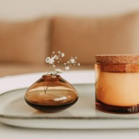 decor elements in the living room of the house a vase with a flower a candle on a glass table beige - home decoration stock pictures, royalty-free photos & images