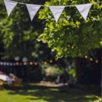decorated garden with set table, flag garland and paper lanterns. garden party, summer festival, birthday party, baptism or wedding. - garden decoration stock pictures, royalty-free photos & images
