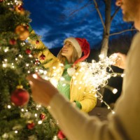 decorating our christmas tree - garden decoration stock pictures, royalty-free photos & images