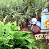 decorative garden with welcome iron signboard - garden decoration stock pictures, royalty-free photos & images