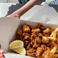 deep fried calamari with fries in paper container - junk food stock pictures, royalty-free photos & images