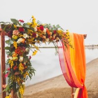 delicate bright wedding arch of flowers and fabric on the sandy shore of a river or lake. beautiful autumn decor, wedding decoration. wedding venue on the beach - home decoration stock pictures, royalty-free photos & images