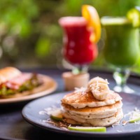 delicious breakfast with croissants, pancakes and two fresh fruit juices - garden decoration stock pictures, royalty-free photos & images