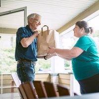 delivering groceries to senior man - food stock pictures, royalty-free photos & images