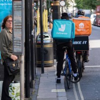 Deliveroo and Just Eat takeaway delivery cycle couriers on Oxford Street on 6th October 2024 in London, United Kingdom. Just Eat Limited is a British...