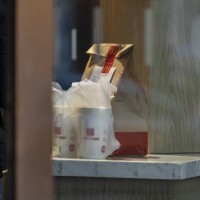 Delivery bag on the counter of a McDonald's Corp. Restaurant in Shanghai, China, on Wednesday, Nov. 22, 2023. Carlyle Group Inc. Agreed to sell its...