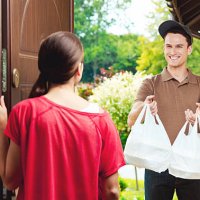 delivery man delivering chinese take away food - junk food stock pictures, royalty-free photos & images