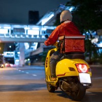 delivery man driving a scooter - food stock pictures, royalty-free photos & images