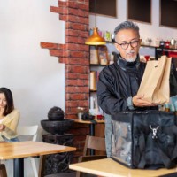 delivery man getting take out food order in restaurant - junk food stock pictures, royalty-free photos & images