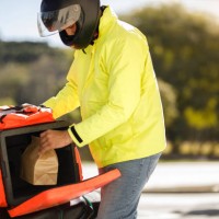 delivery man taking the order out of the backpack - motoboy - food stock pictures, royalty-free photos & images