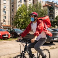 delivery man working during coronavirus pandemic - junk food stock pictures, royalty-free photos & images