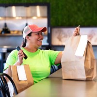 delivery person picking up restaurant takeout food order - junk food stock pictures, royalty-free photos & images