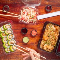 delivery style asian food consisting of avocado sushis, fried rice with shrimps and vegetable salad served with soya sauce, pickled ginger, wasabi and sticks - junk food stock pictures, royalty-free photos & images