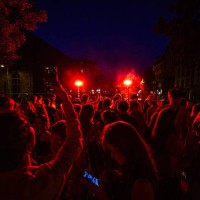 Dense crowd bathes in red stage lights at night during an open-air concert for the Fete de la Musique in Clermont-Ferrand France on June 21 2025.