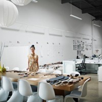 designer standing at conference table - fashion stock pictures, royalty-free photos & images
