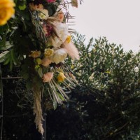 detail of a wedding arch with a large centerpiece decorated with flowers - garden decoration stock pictures, royalty-free photos & images