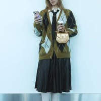 Devyn Ramnarain of Naples, Florida wears a cardigan by Straight to Hell, a shirt by Helmut Lang with a tie by Prada, a faux leather skirt, shoes by...