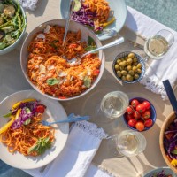 dining table with plates and bowls of food outdoors. - food stock pictures, royalty-free photos & images