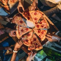 dinner party with friends - high angle view of people taking pizza slices - junk food stock pictures, royalty-free photos & images