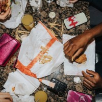 directly above shot of friends eating fast food and drinks on table at nightclub - junk food stock pictures, royalty-free photos & images
