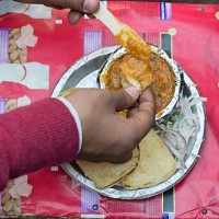 Directly Above Shot Of Man Eating Pav Bhaji.