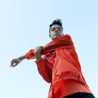 directly below portrait of athlete stretching arm against clear sky - fashion stock-fotos und bilder