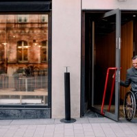 disabled mature man with shopping bag leaving store in city - junk food stock pictures, royalty-free photos & images