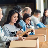 diverse adults packing donation boxes in charity food bank - food stock pictures, royalty-free photos & images